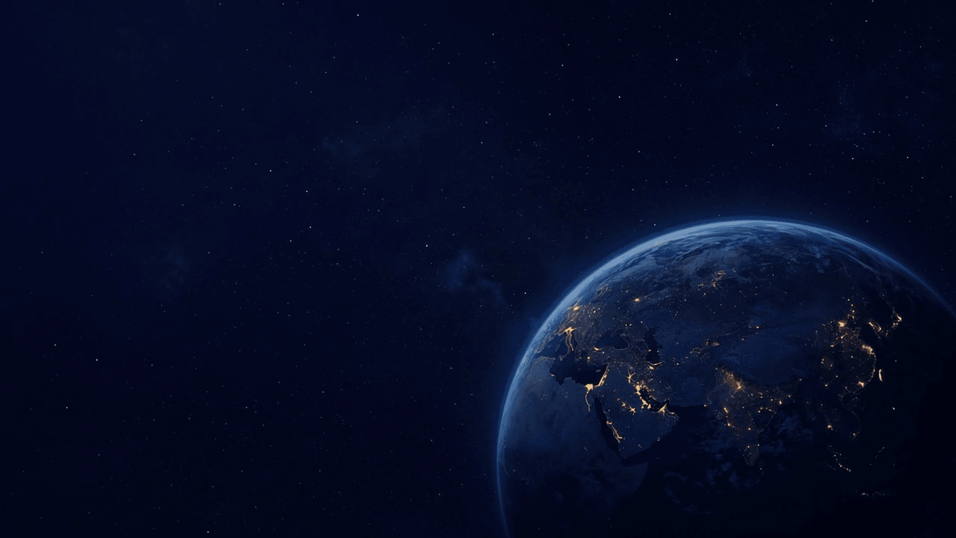 Earth seen from deep space, night side beginning to appear.